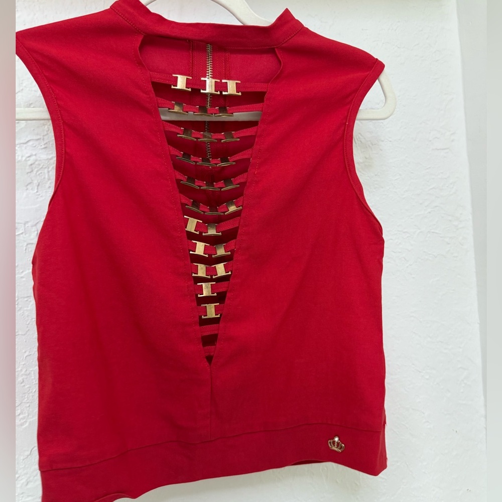 Red plunge neck top with gold hardware accents